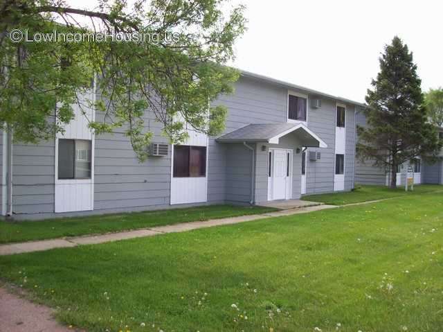 Crooks Apartments: photograph of a two story housing structure with an entrance and 2 sets of windows on each side of the entrance. 