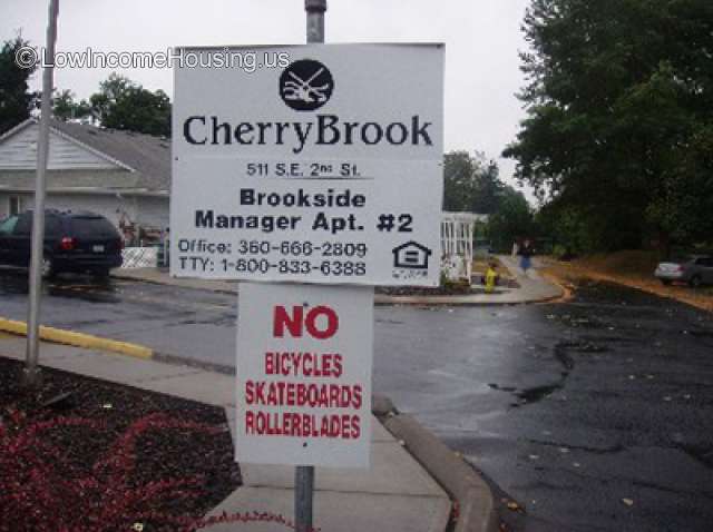 This is a photograph of an advertisement for an apartment manager at CherryBrook.  There is also a sign that says No Bicycles, No Skateboards, No rollerblades.