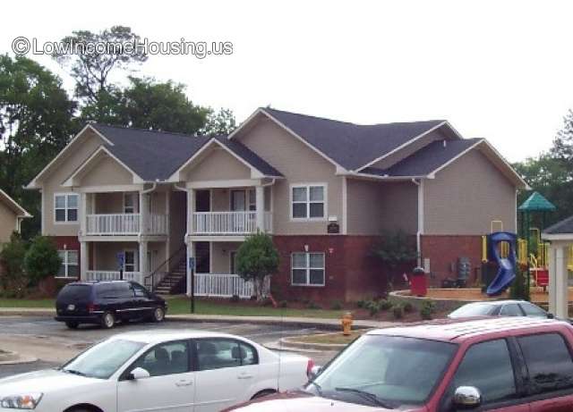 The photograph contains the pictures of two buildings which are identical.  They are two flights of stairs each, 2 windows each, two sitting areas each. 