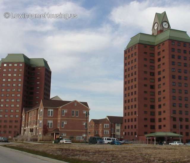 Photograph of two large apartment buildings with 14 floors, 4 apartments per floor.