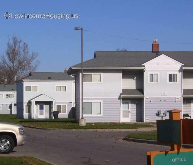 White clapboard housing units with 6 bedrooms and easy access to street.