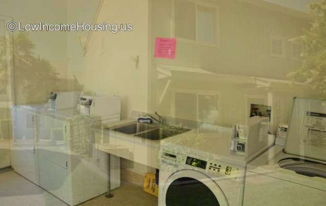 Completely furnished coin operated washer/dryer with utility sink.