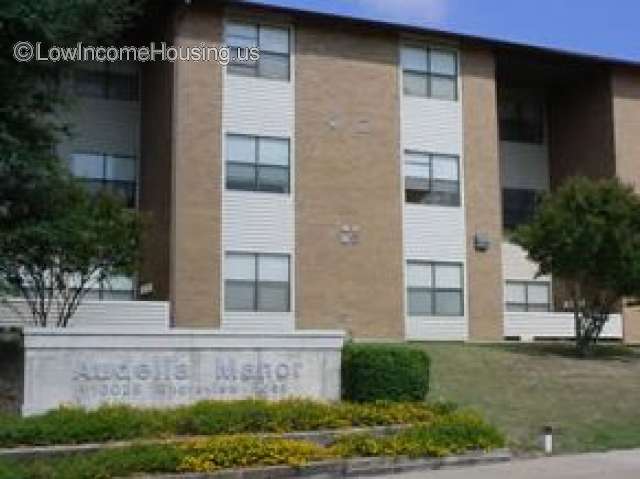 Twin housing units with exterior lighting, lush garden foliage and sidewalks with easy access to units.   