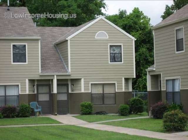 Twin dormer cottage units with installed fencing, large windows  and concrete pathways. 