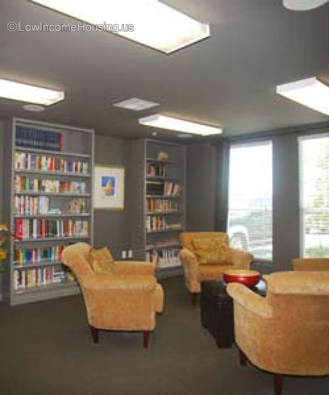 Unit library area equipped with large, comfortable seating, ample selection of reading material, ample use of natural lighting.