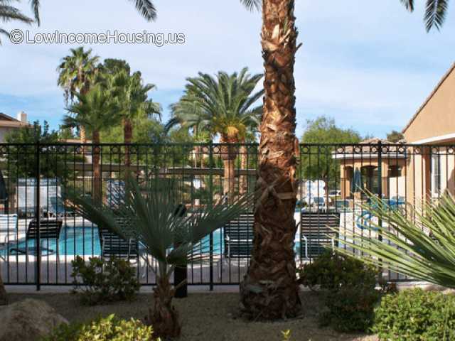 Swimming pool shown in housing development.  Buildings appear to be masonry finish. 